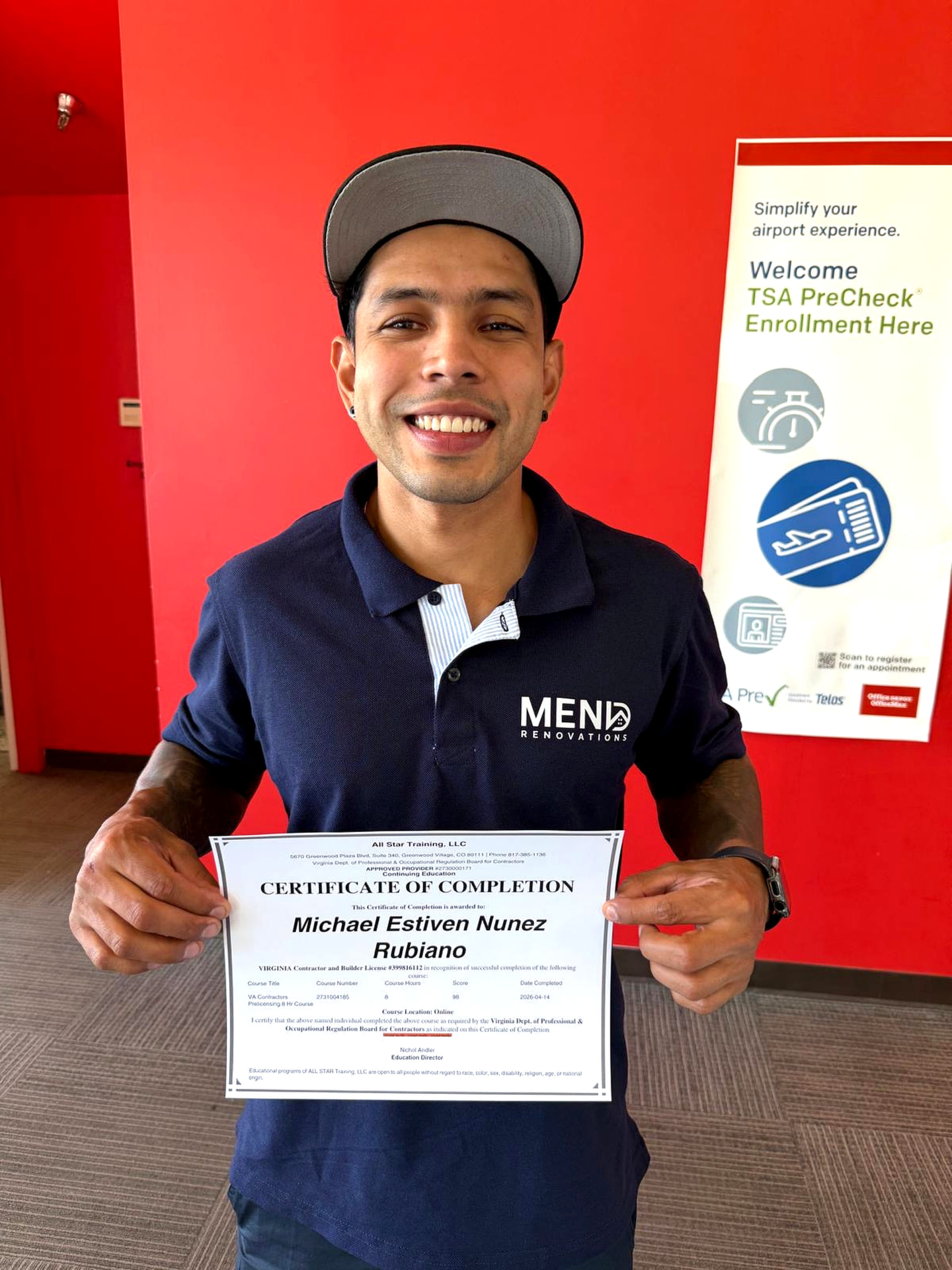 Michael Núñez of Mend Renovations holding a certificate of completion